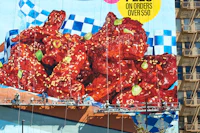 a large mural of chicken wings on the side of a building