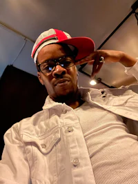 a man wearing a white jacket and a white hat