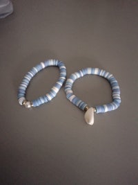 two blue and white bracelets on a table