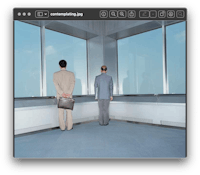 two men standing in front of a large window