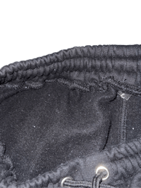 a close up of a black hooded sweatshirt on a black background