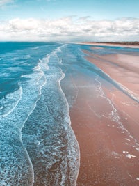 an aerial view of a beach and ocean