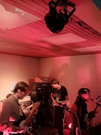 a group of people playing a musical instrument in a room