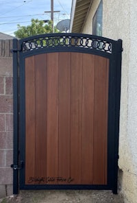 a wooden gate in front of a house