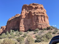 a jeep parked in front of a red rock formation