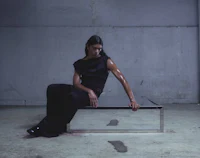 a woman sitting on a table in a dark room