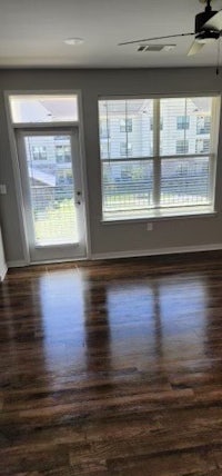 a living room with hardwood floors and a ceiling fan