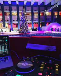a dj set up in front of a christmas tree