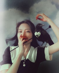 a woman with a bird on her head