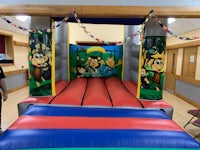 a man is standing in front of an inflatable bouncer