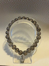 a silver bracelet on a silver plate