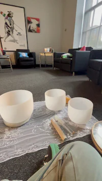 three white bowls on the floor in a room