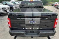 the back end of a black ford f - 150 truck