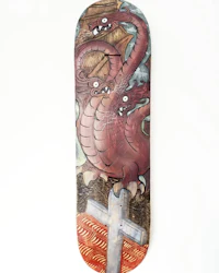 a skateboard with a red dragon on it