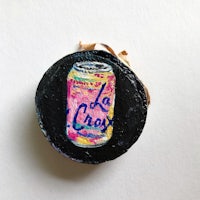 a pin with the word la chay painted on it