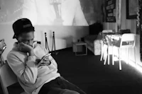 a man sitting in a chair looking at his phone