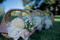 wicker baskets filled with flowers on the grass
