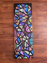 a stained glass painting on a wooden floor