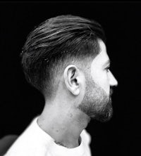 a black and white photo of a man with a beard