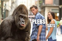 a man and a woman are standing next to a gorilla