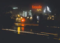 a city at night with a sign that says knoxville light