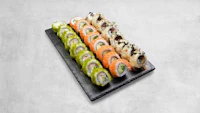 a tray of sushi on a concrete surface