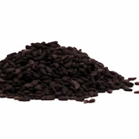 a pile of black seeds on a white background