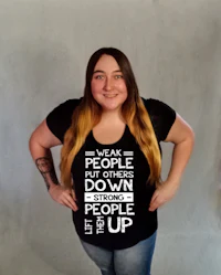 a woman wearing a black t - shirt that says we are people