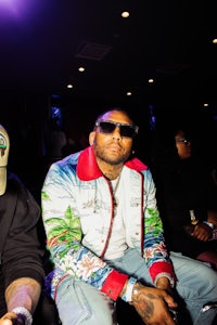 two men sitting next to each other at an event