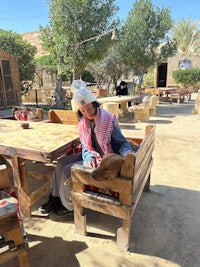 a man sitting on a wooden bench