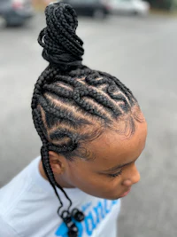 a young girl with braids in her hair