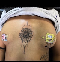 a woman with a sunflower tattoo on her chest