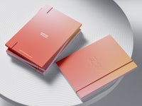 two pink and orange notebooks on a white background
