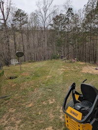 a lawn mower in the middle of a wooded area