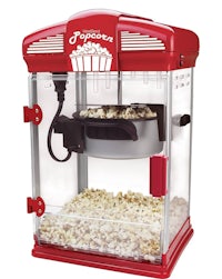 a red popcorn machine with popcorn in it