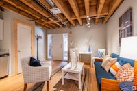a living room with wood beams and a couch
