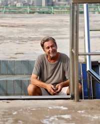 a man sitting on the steps of a building