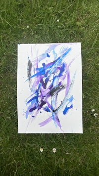 a painting with blue and purple paint on the grass