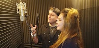 a man and a woman singing in a recording studio