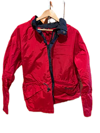 a red jacket hanging on a hanger