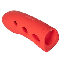 a red plastic sex toy with holes in it