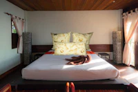 a bedroom with a bed and pillows