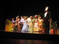 a group of children on stage in costumes