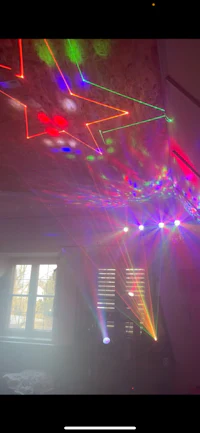 a room with a colorful light show in the ceiling
