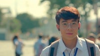 a young man wearing glasses and a backpack