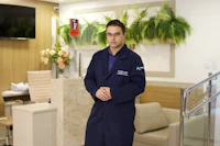 a man in a lab coat standing in a waiting room
