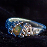 a silver ring with an opal in it