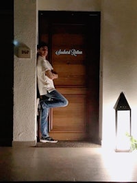a man standing in front of a wooden door