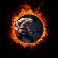 a man playing an acoustic guitar in a circle of fire