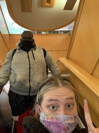 a woman wearing a face mask and a man on an escalator